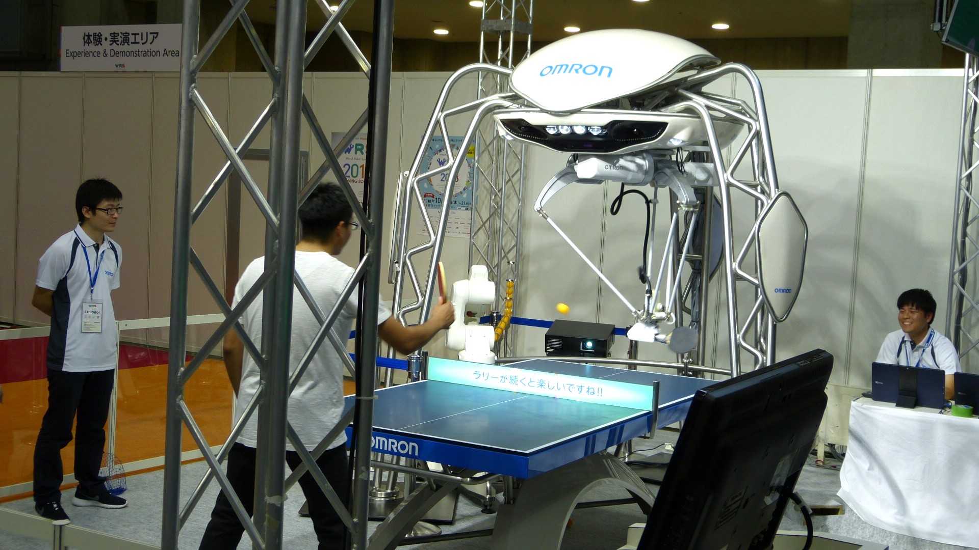 a robot arm attached to a frame plays ping pong against a human